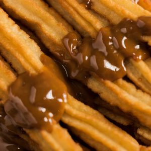 close-up-fried-churros-with-melted-chocolate_23-2148379621